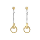 A pair of silver snaffle bit drop earrings with gold accents, featuring butterfly back closures, displayed against a white background.